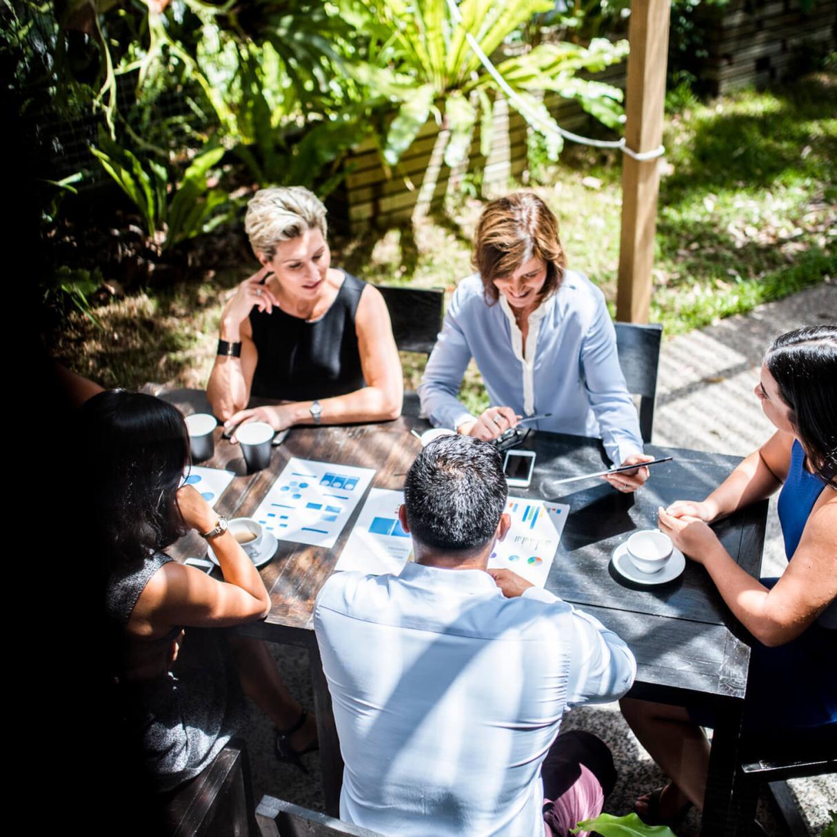 People having a business meeting at an outside restaurant table